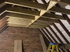 Loft conversion, new timber joists going in under the old roof