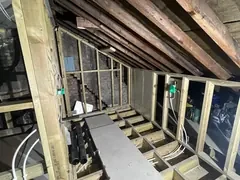 New loft floor with pipes and cables run between the joists